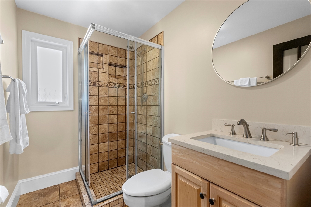 21 Leggs Hill Road Marblehead, MA 01945 - Photo 13 of 38 a bathroom with a sink a toilet a mirror and shower