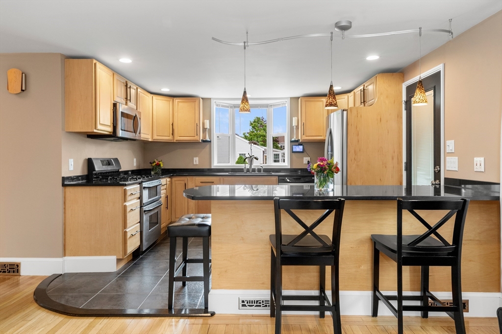 21 Leggs Hill Road Marblehead, MA 01945 - Photo 6 of 38 a kitchen with stainless steel appliances kitchen island granite countertop a stove a sink and a refrigerator