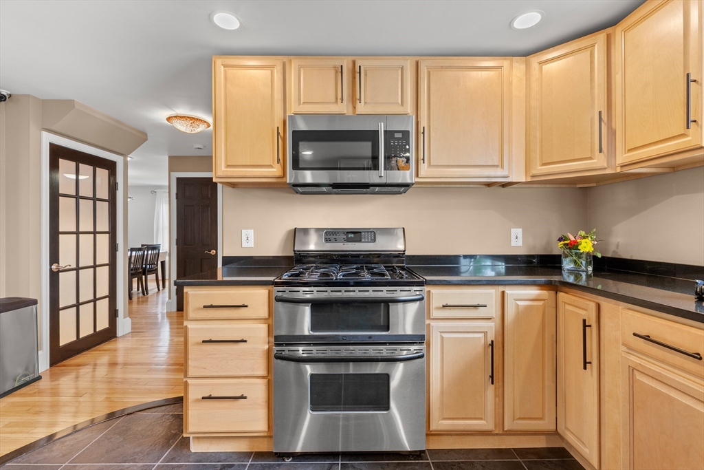 21 Leggs Hill Road Marblehead, MA 01945 - Photo 9 of 38 a kitchen with stainless steel appliances granite countertop a stove and a microwave