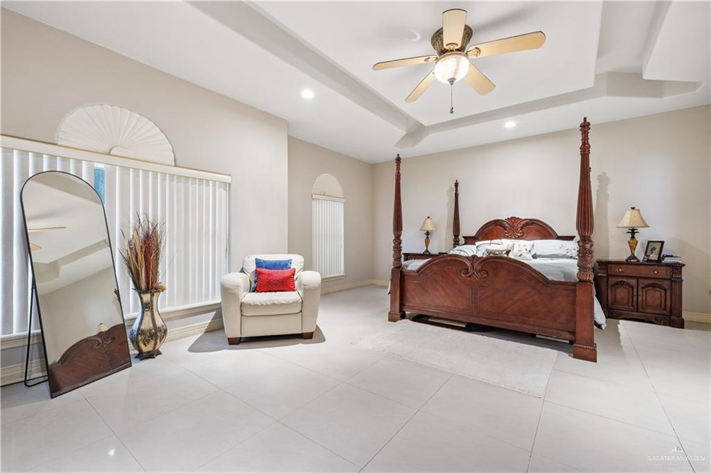 2005 East 28th Street Mission, TX 78574 - Photo 12 of 28 a bedroom with a bed and a chandelier