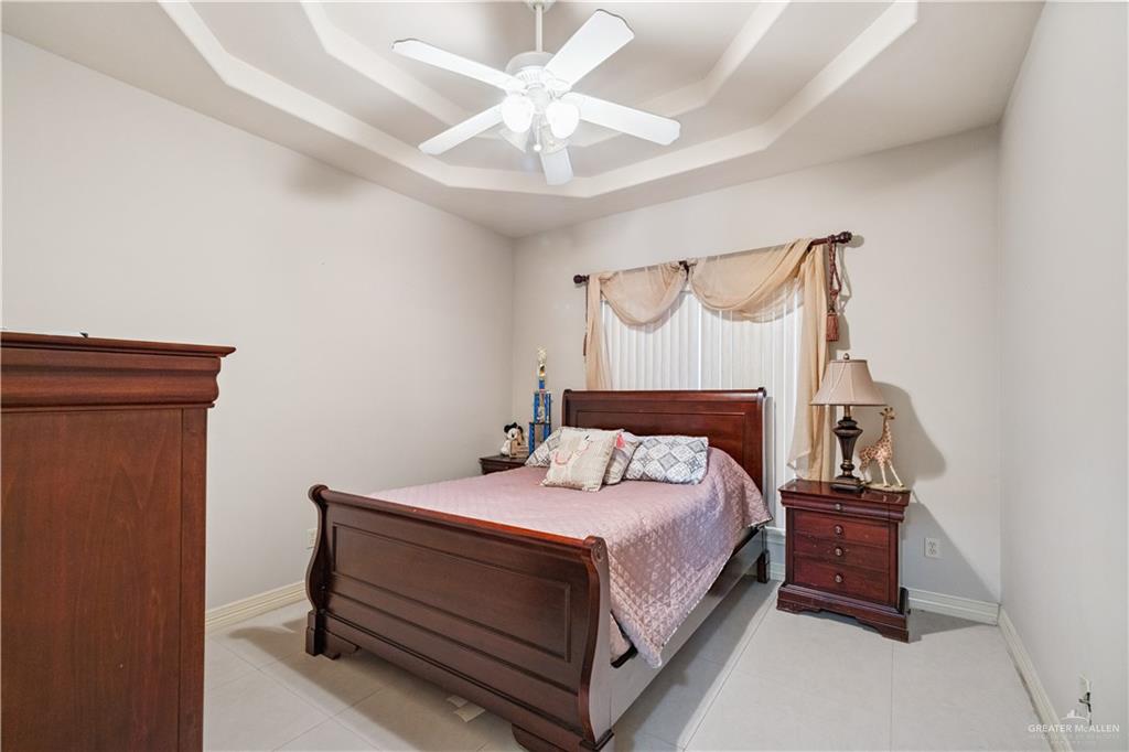 2005 East 28th Street Mission, TX 78574 - Photo 16 of 28 a bedroom with a bed and a ceiling fan