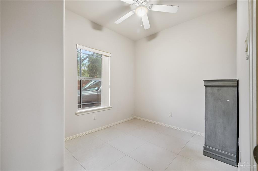 2005 East 28th Street Mission, TX 78574 - Photo 19 of 28 an empty room with chandelier fan and windows