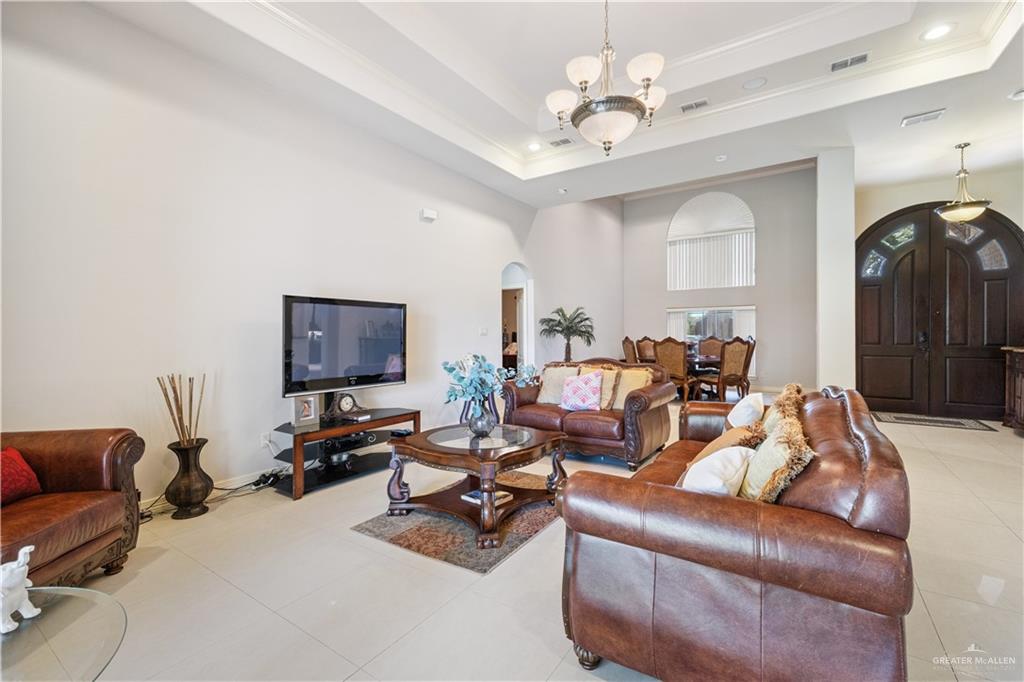 2005 East 28th Street Mission, TX 78574 - Photo 6 of 28 a living room with furniture a large window and a chandelier