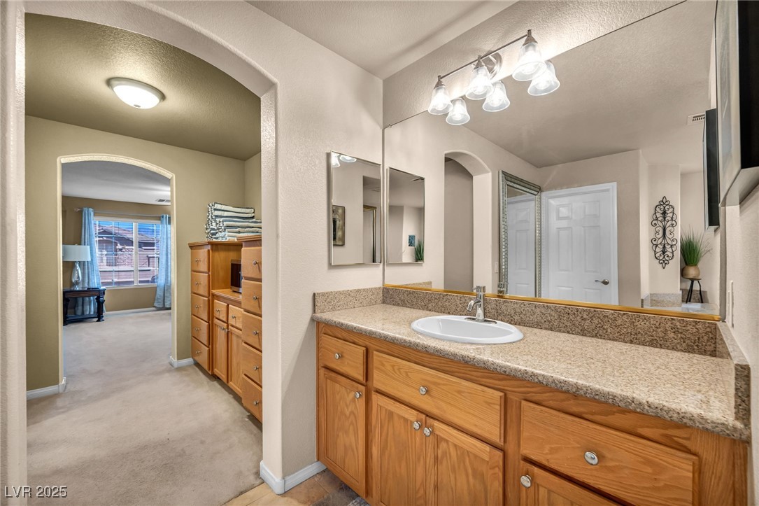 8929 Glenistar Gate Avenue Las Vegas, NV 89143 - Photo 47 of 96 Primary Suite hallway that leads to a Grand Walk in closet and a private sitting area perfect for a work out room or your own theater room!