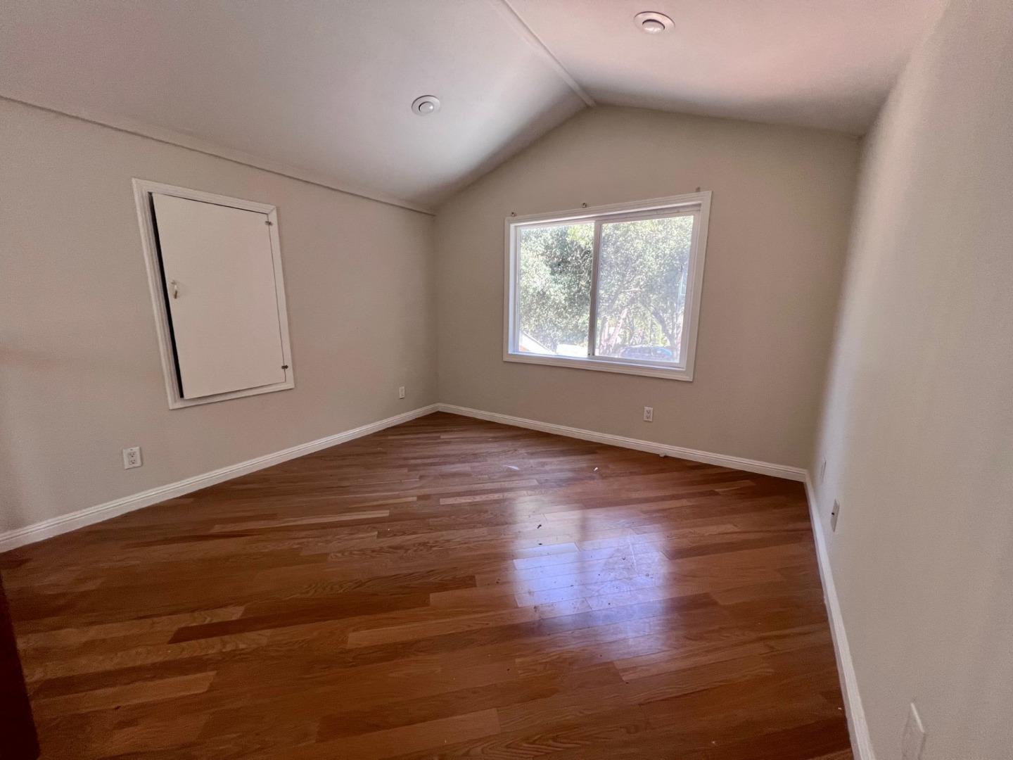 14004 Clayton Road San Jose, CA 95127 - Photo 16 of 43 an empty room with wooden floor and windows