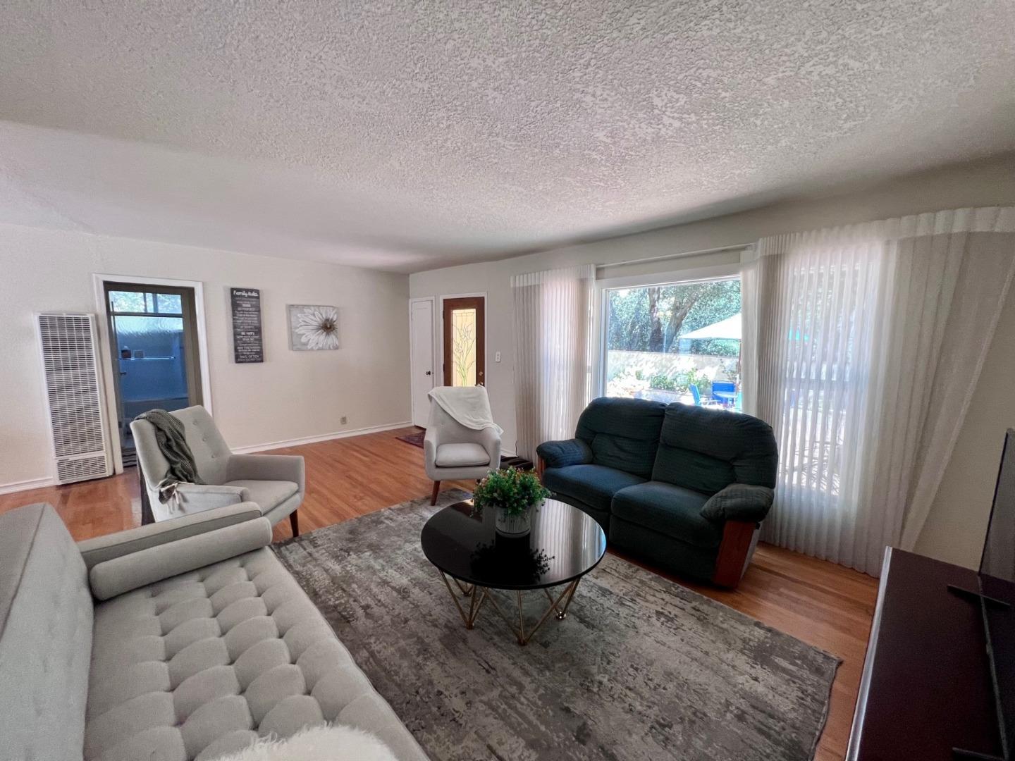 14004 Clayton Road San Jose, CA 95127 - Photo 21 of 43 a living room with furniture a rug a window and a flat screen tv