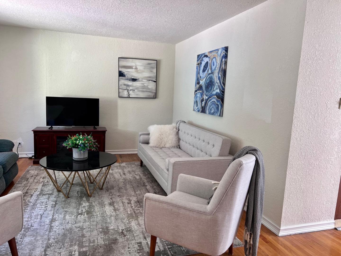 14004 Clayton Road San Jose, CA 95127 - Photo 24 of 43 a living room with furniture a flat screen tv and a table