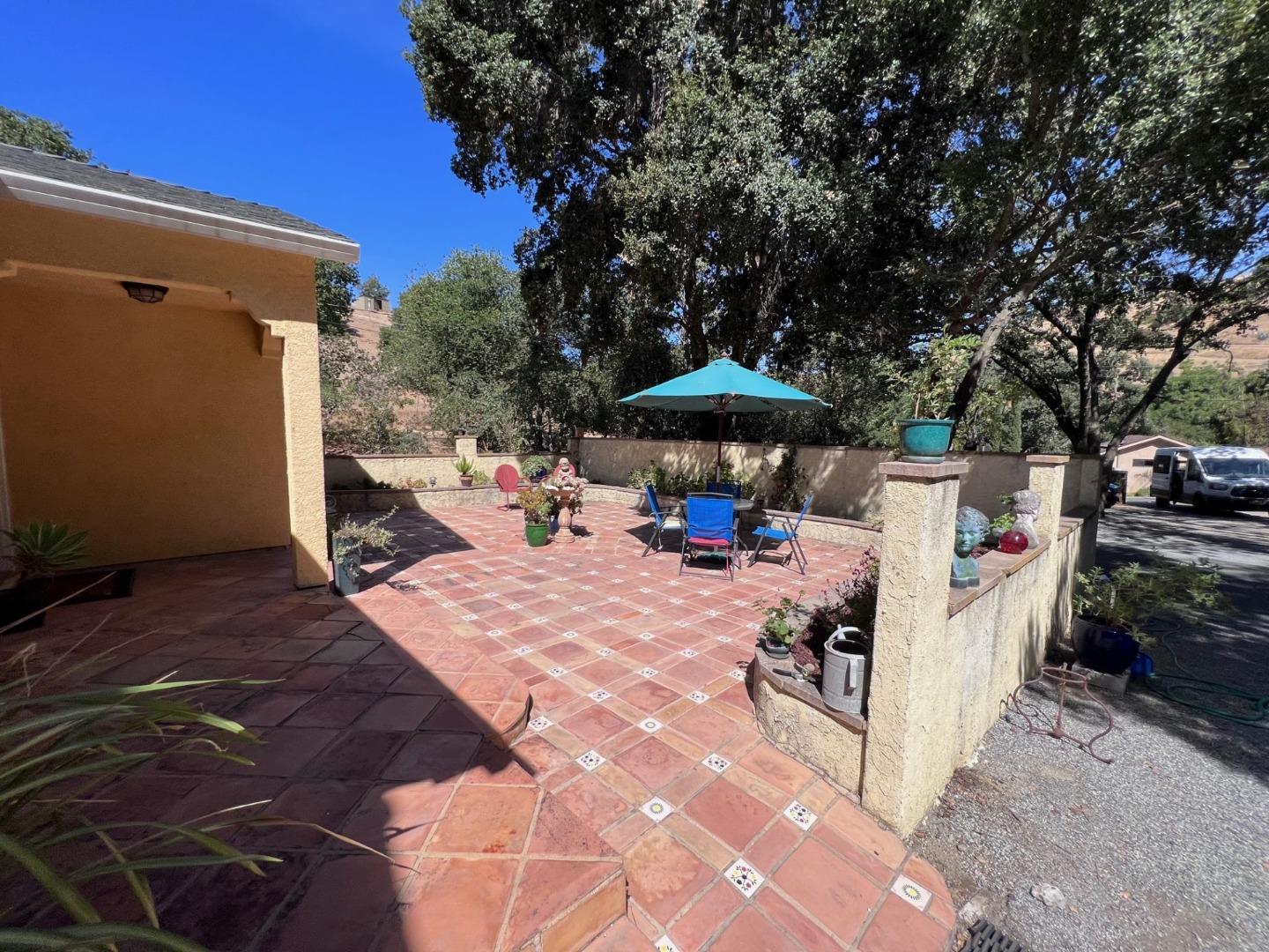 14004 Clayton Road San Jose, CA 95127 - Photo 4 of 43 a view of a patio with table and chairs under an umbrella with a barbeque