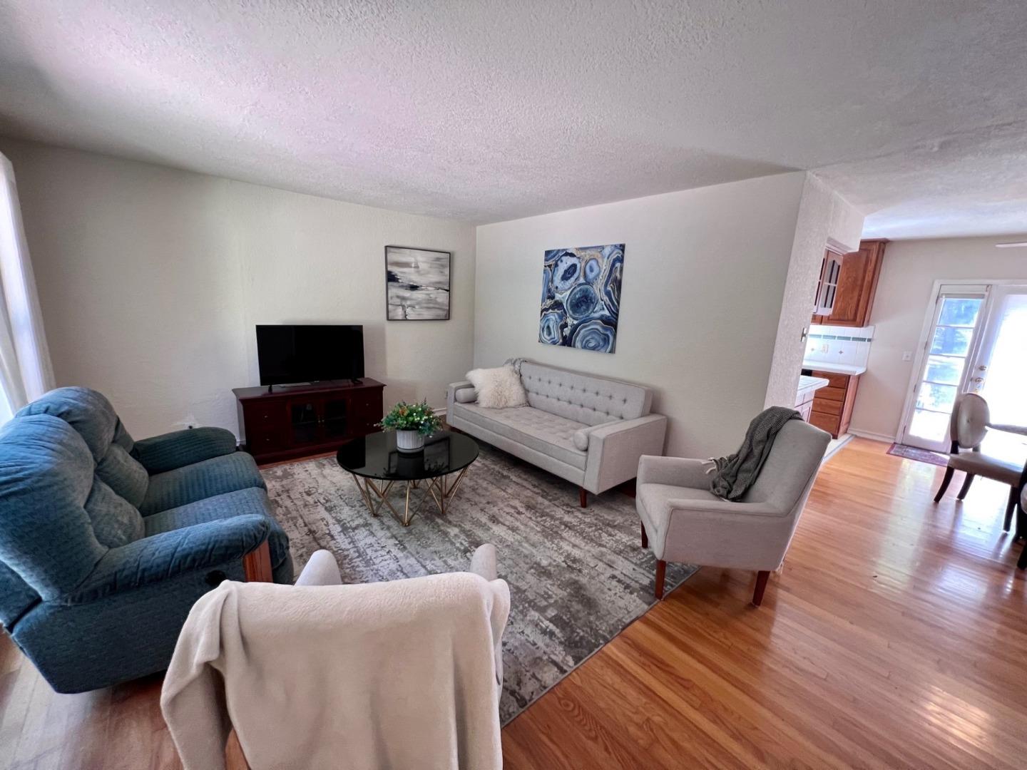 14004 Clayton Road San Jose, CA 95127 - Photo 8 of 43 a living room with furniture wooden floor and a flat screen tv