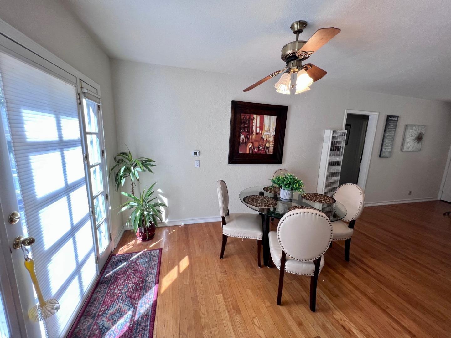14004 Clayton Road San Jose, CA 95127 - Photo 9 of 43 a dining room with furniture a chandelier and wooden floor