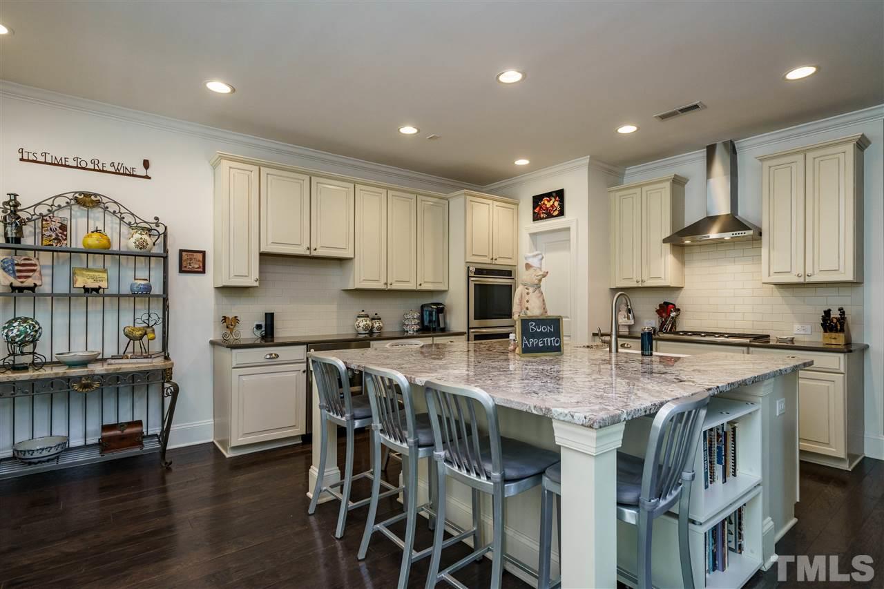 4005 Periwinkle Blue Lane Raleigh, NC 27612 - Photo 7 of 29 ...has upgraded appliances, a huge island, a farm sink, and a beverage 'fridge