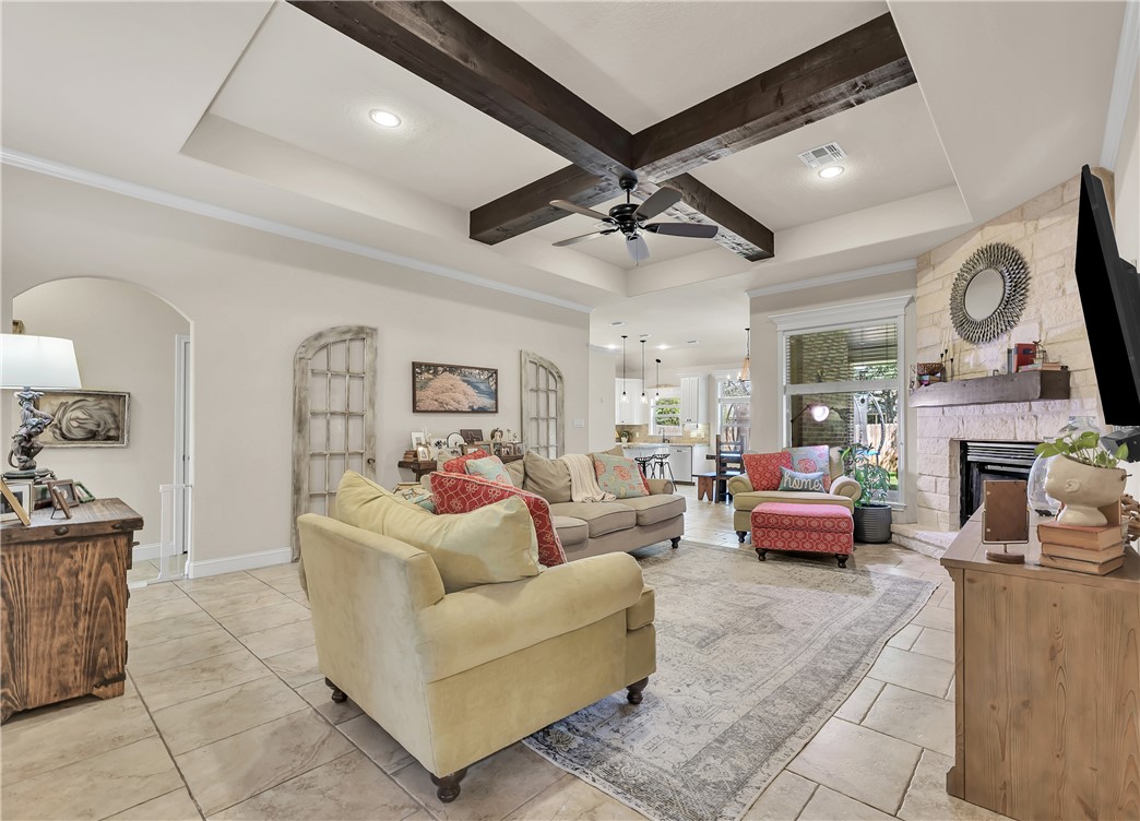 8312 Raintree Drive College Station, TX 77845 - Photo 2 of 30 Spacious living area featuring a tray ceiling with exposed wood beams, ceiling fan, and recessed lighting
