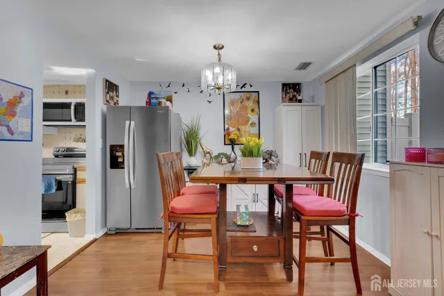 a dining room with furniture a chandelier and window
