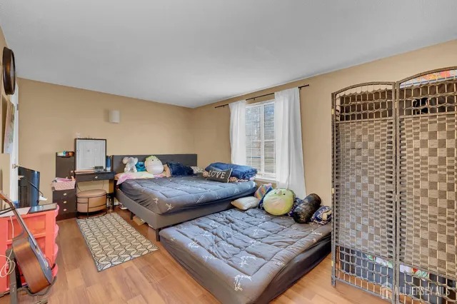 a bedroom with furniture and a window