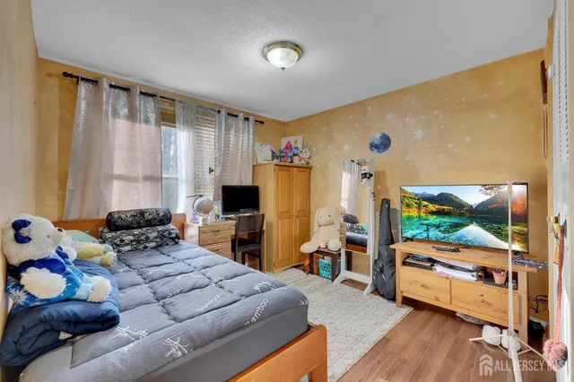 a bedroom with furniture and a flat screen tv