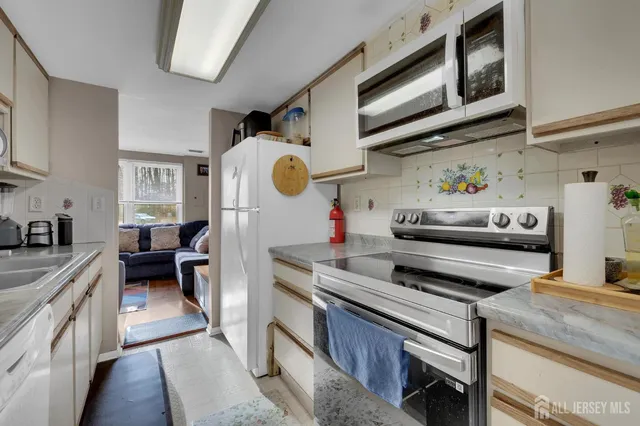 a kitchen with furniture a stove and a window