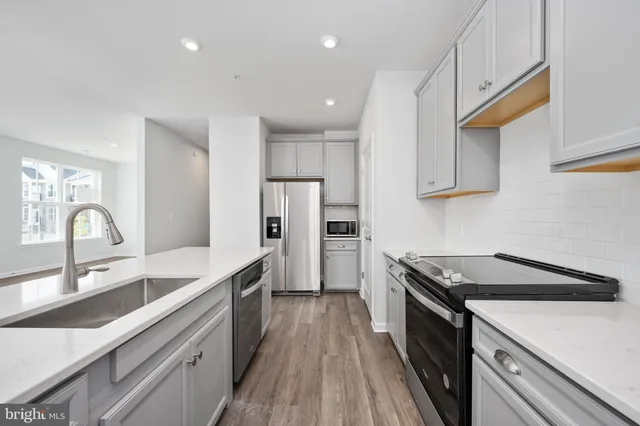 a view of a kitchen with refrigerator and cabinet