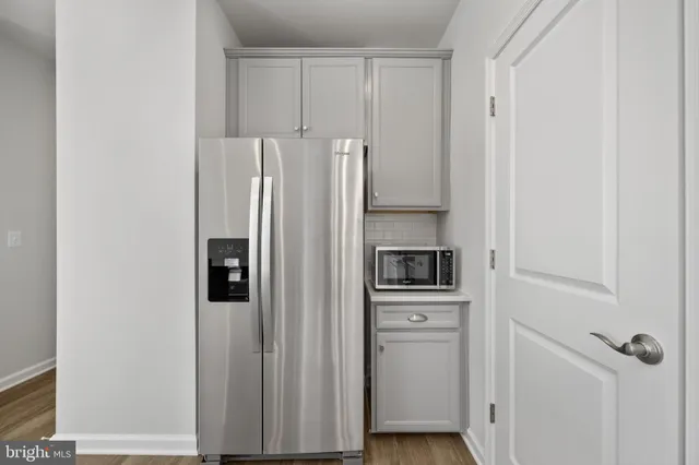a kitchen with granite countertop a sink a stove and cabinets