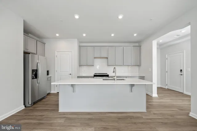 a kitchen with a stove a sink and a refrigerator