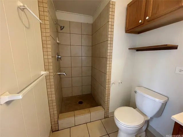 a bathroom with a toilet and a shower