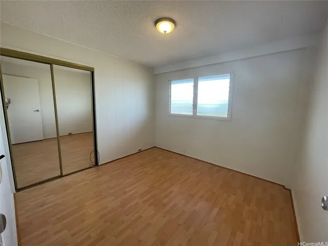 an empty room with fan and windows