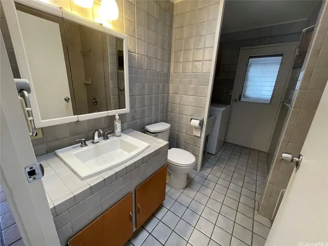 a bathroom with a sink toilet and mirror