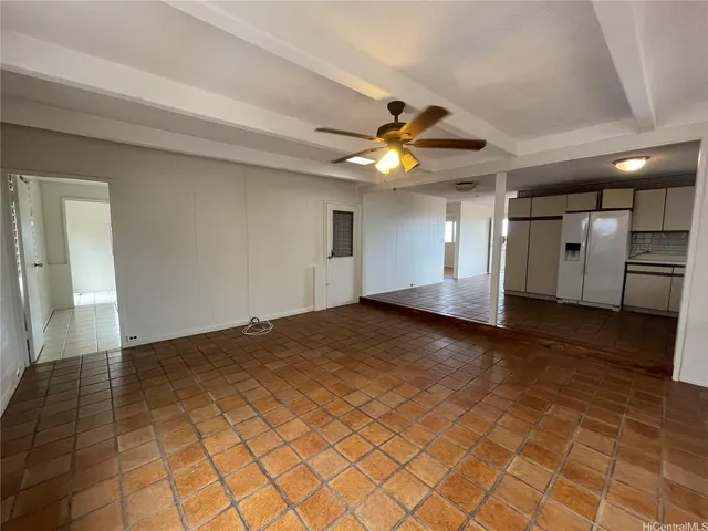 a view of a livingroom with a ceiling fan and window