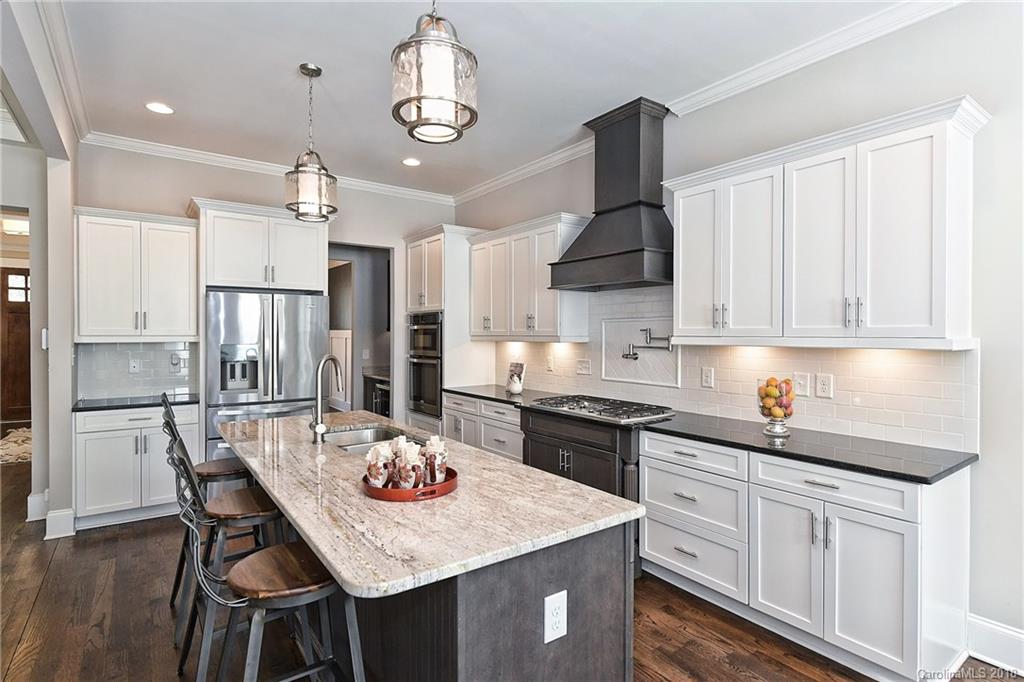 1624 Brook Road Charlotte, NC 28205 - Photo 16 of 34 a kitchen with kitchen island granite countertop a sink a center island and cabinets