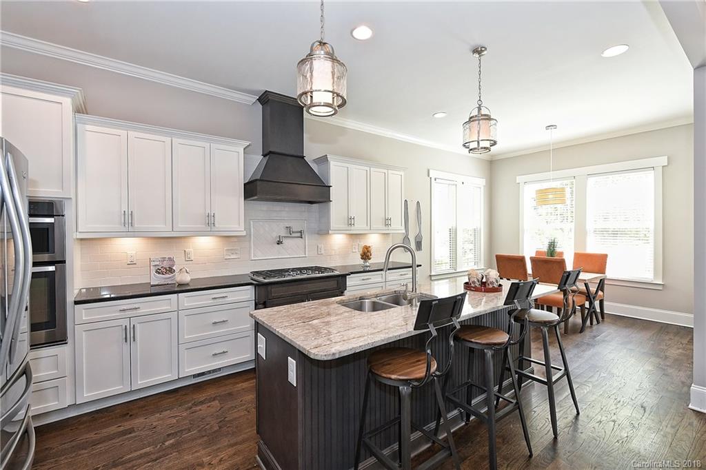 1624 Brook Road Charlotte, NC 28205 - Photo 17 of 34 a kitchen with stainless steel appliances granite countertop a sink stove and refrigerator