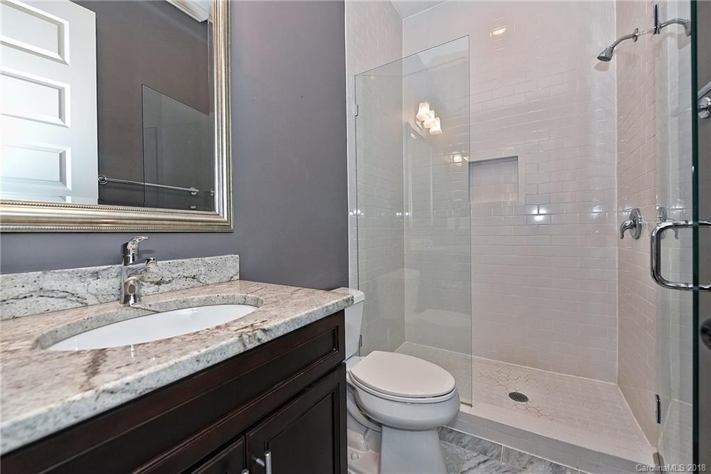 1624 Brook Road Charlotte, NC 28205 - Photo 20 of 34 a bathroom with a granite countertop sink a toilet and shower