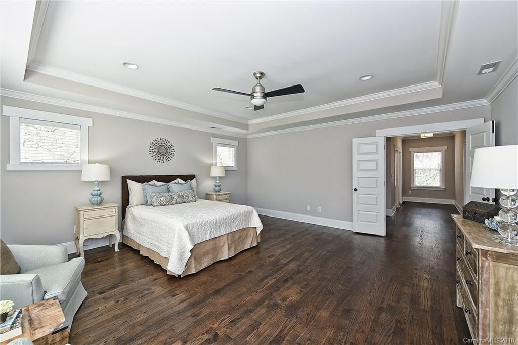 1624 Brook Road Charlotte, NC 28205 - Photo 23 of 34 a bedroom with a bed and wooden floor