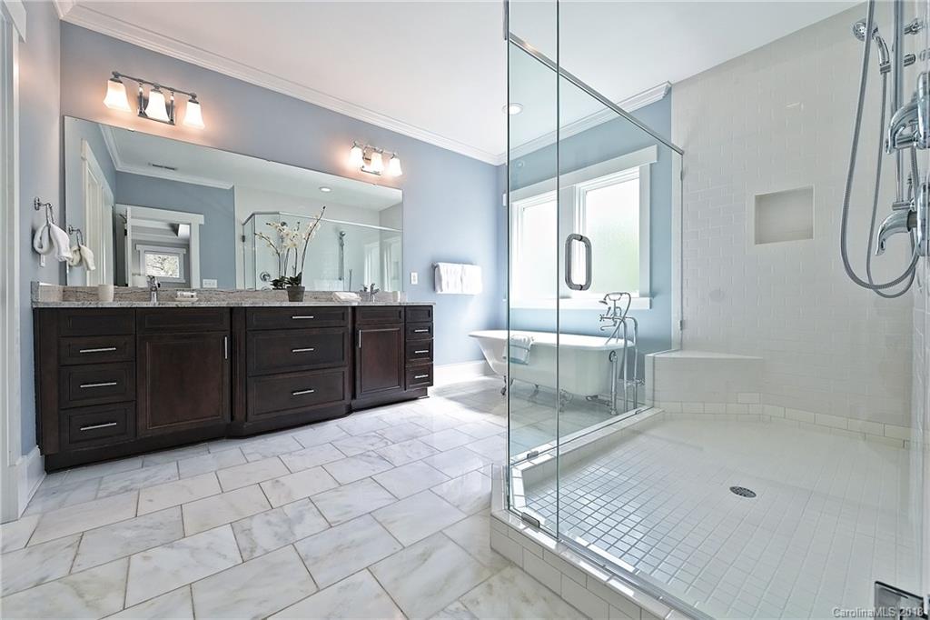1624 Brook Road Charlotte, NC 28205 - Photo 25 of 34 a bathroom with a sink a vanity a mirror and a bathtub