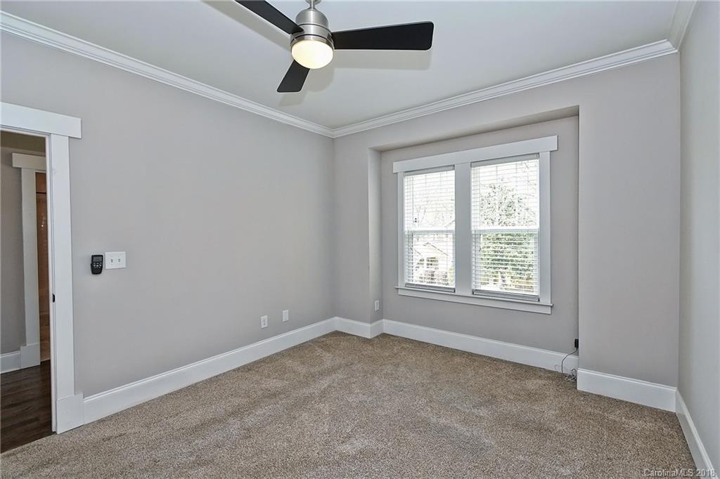 1624 Brook Road Charlotte, NC 28205 - Photo 27 of 34 an empty room with a window and a fan