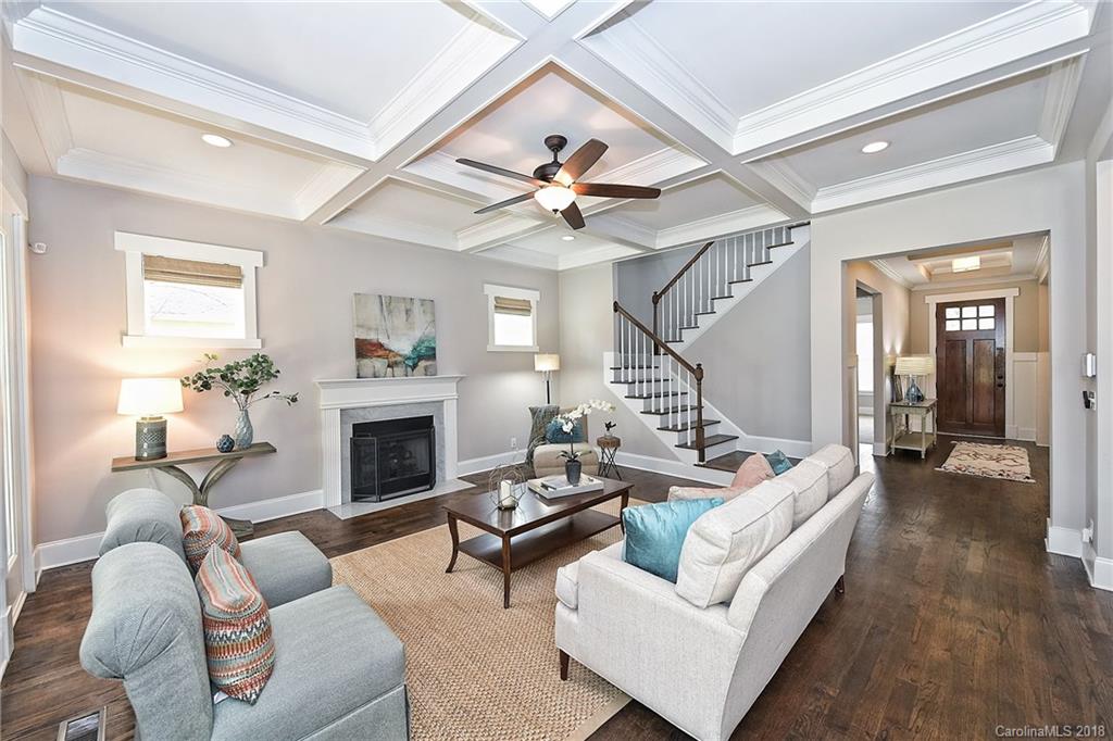 1624 Brook Road Charlotte, NC 28205 - Photo 10 of 34 a living room with furniture a fireplace and a ceiling fan