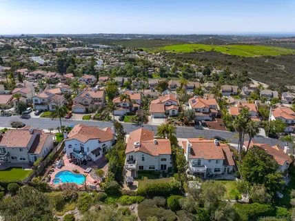an aerial view of residential houses with outdoor space