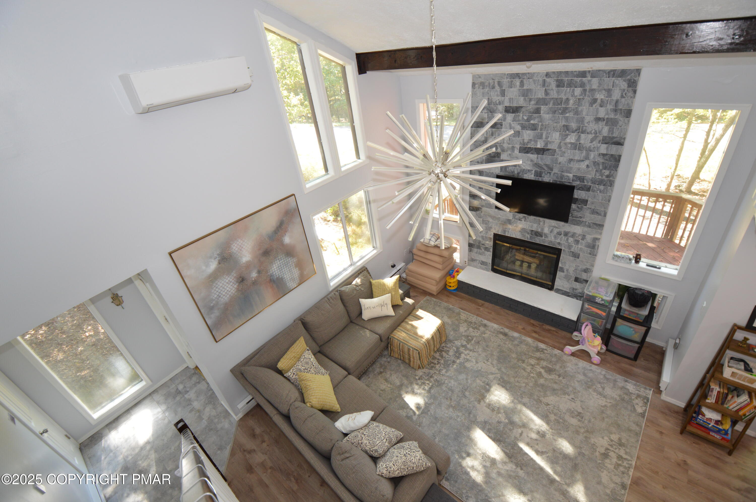 128 Ashley Court Bushkill, PA 18324 - Photo 12 of 43 a living room with furniture a fireplace and a flat screen tv