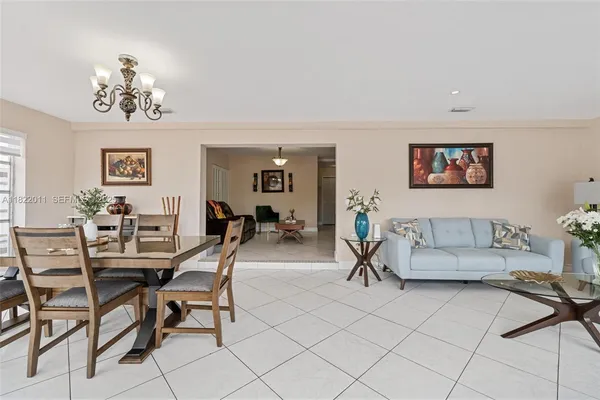a view of hallway with furniture and flowers