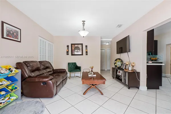 a bedroom with furniture and a flat screen tv