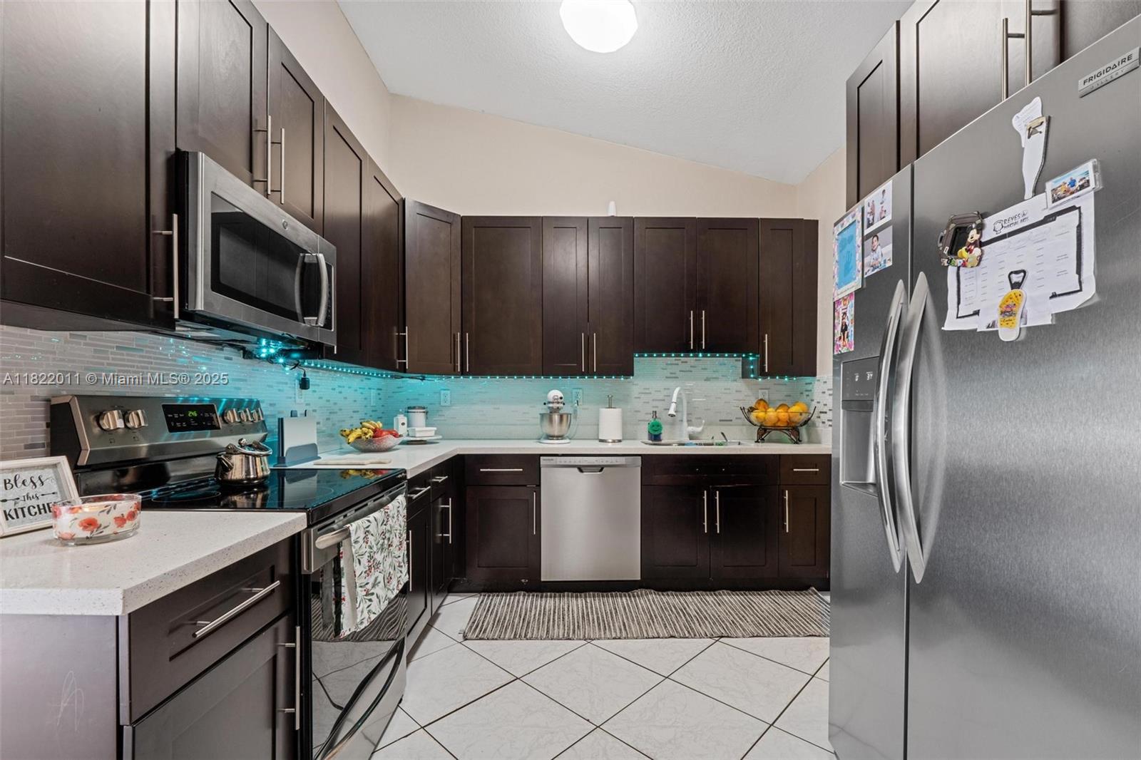 230 West 47th Street Hialeah, FL 33012 - Photo 21 of 58 a kitchen with stainless steel appliances granite countertop a refrigerator and a stove top oven