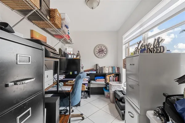 a bedroom with a bed and a television