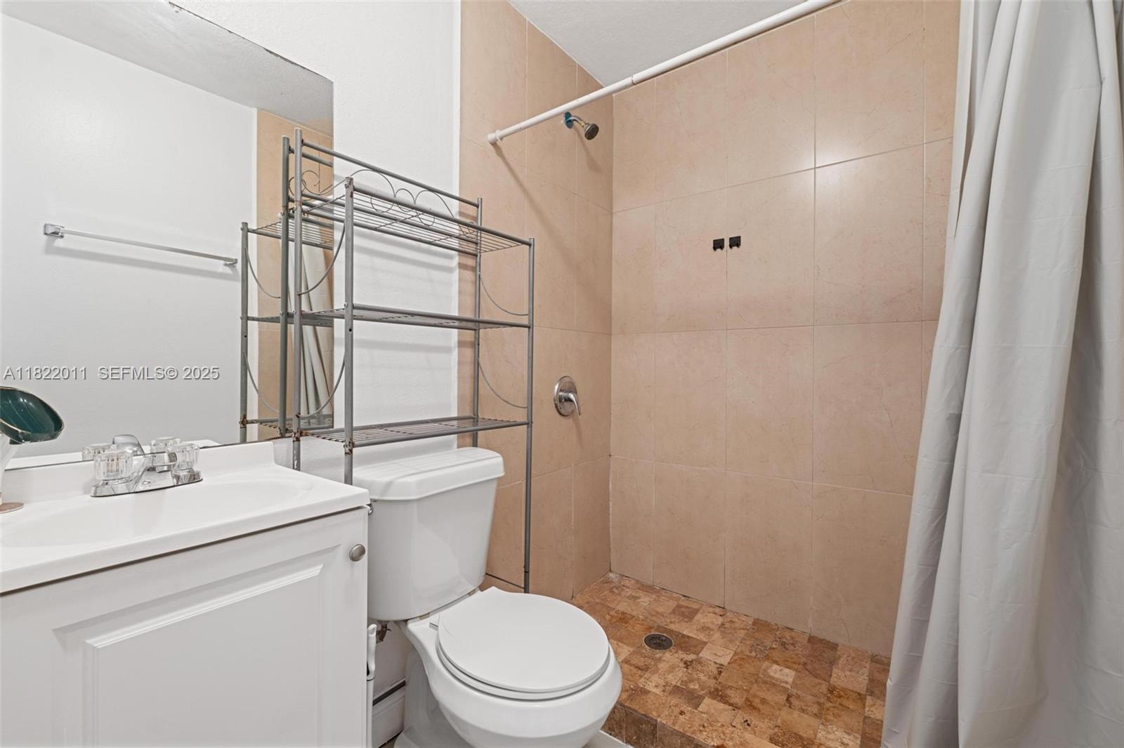 230 West 47th Street Hialeah, FL 33012 - Photo 25 of 57 a bathroom with a sink toilet vanity and shower