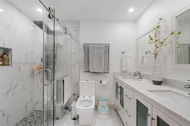 a bathroom with a sink toilet and a mirror