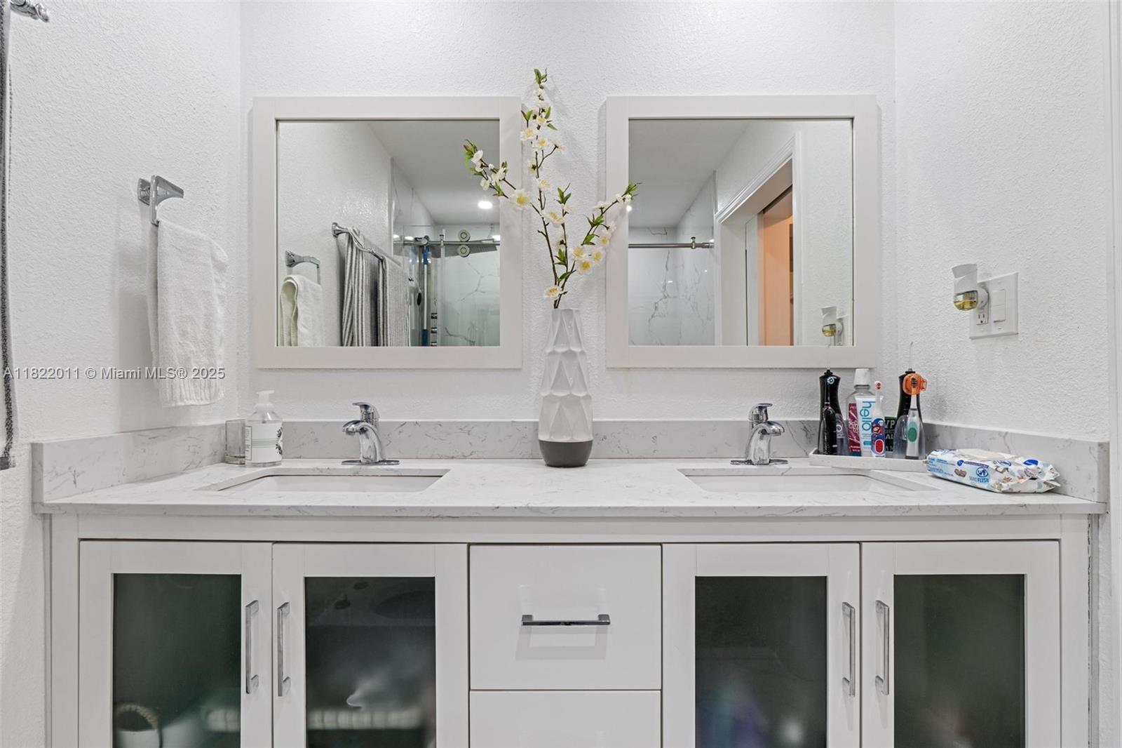 230 West 47th Street Hialeah, FL 33012 - Photo 36 of 58 a bathroom with double sink and a mirror