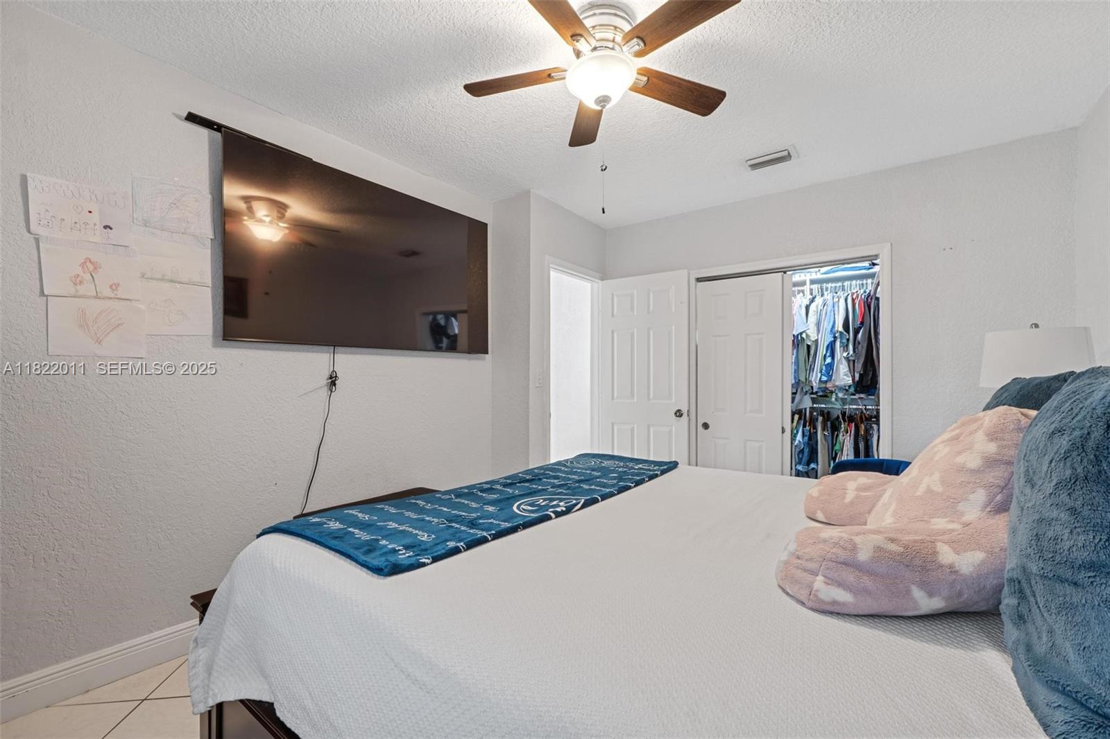 230 West 47th Street Hialeah, FL 33012 - Photo 42 of 57 a bedroom with a bed and a flat screen tv