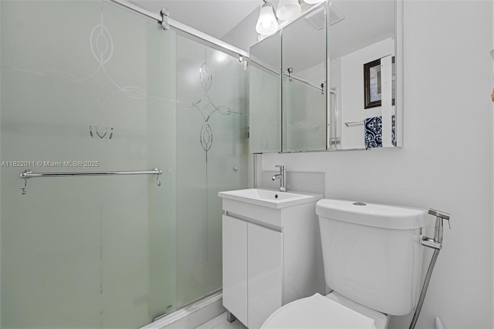 230 West 47th Street Hialeah, FL 33012 - Photo 44 of 58 a bathroom with a toilet sink and mirror
