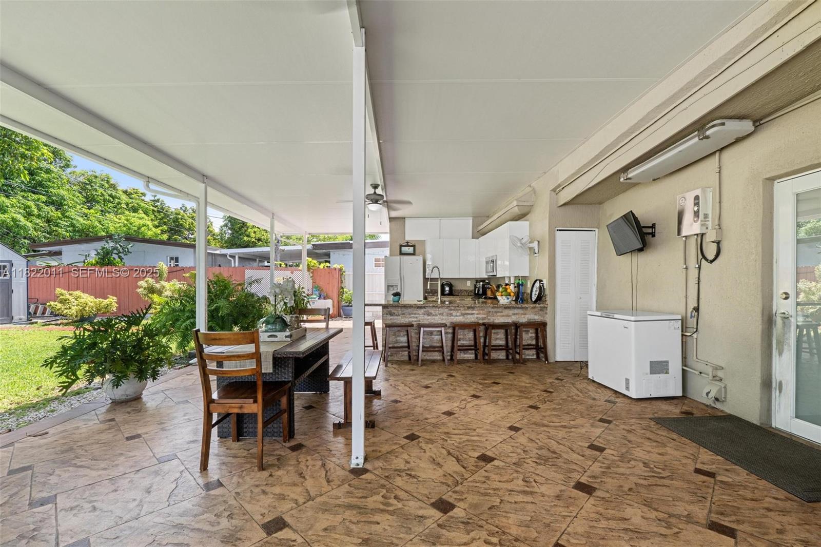 230 West 47th Street Hialeah, FL 33012 - Photo 48 of 57 a outdoor space with chairs a stove a refrigerator and a fireplace