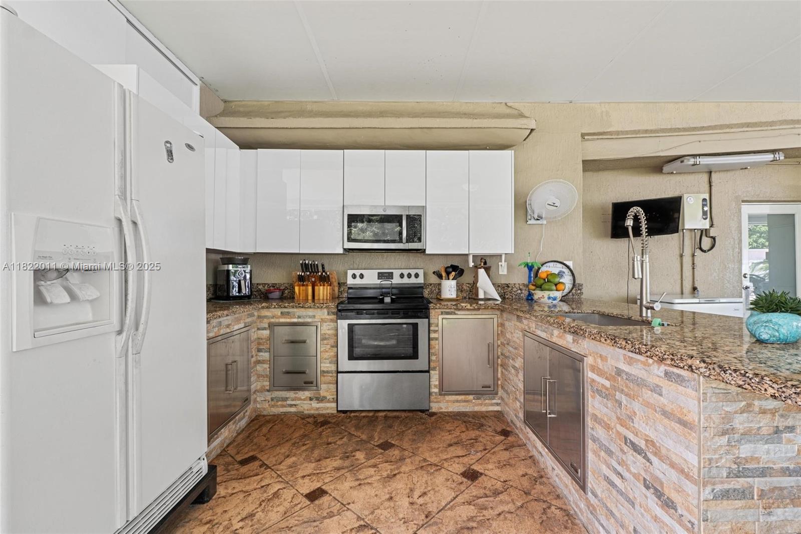 230 West 47th Street Hialeah, FL 33012 - Photo 51 of 58 a kitchen with a sink stove and refrigerator