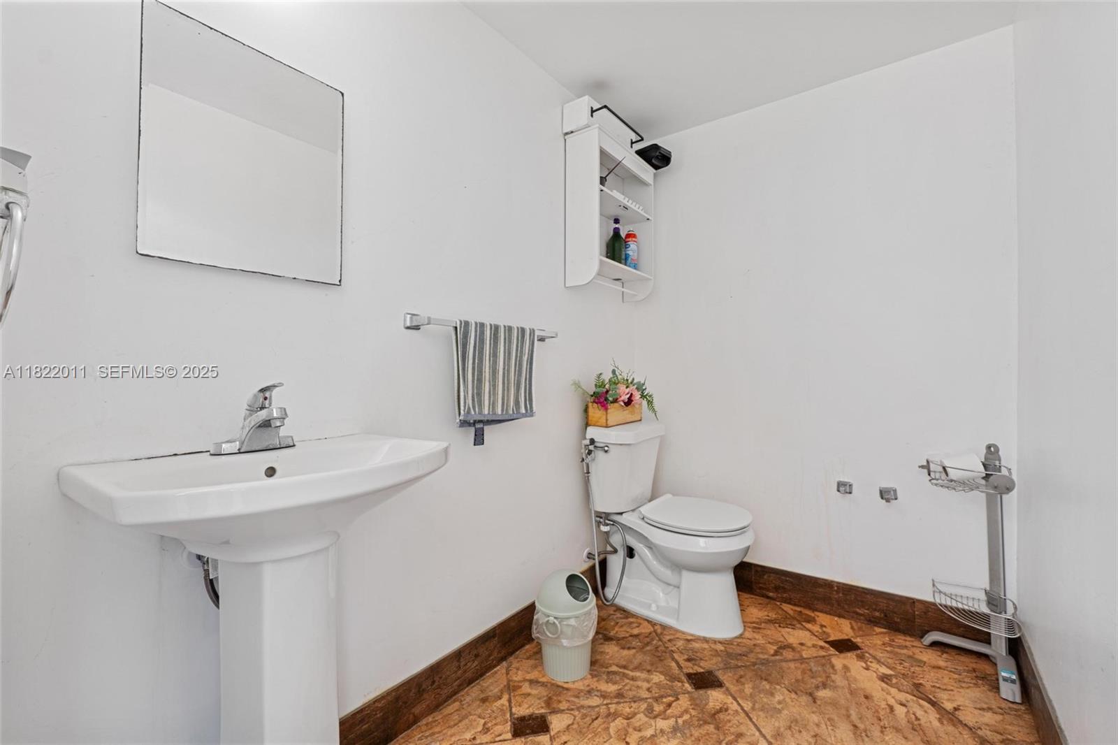 230 West 47th Street Hialeah, FL 33012 - Photo 52 of 57 a bathroom with a sink toilet and a mirror