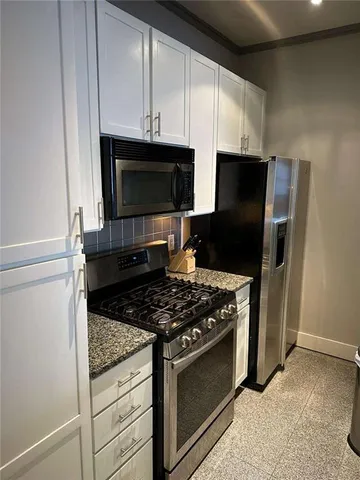 a bathroom with a toilet and a mirror