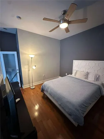 a bathroom with a granite countertop toilet a sink and a mirror